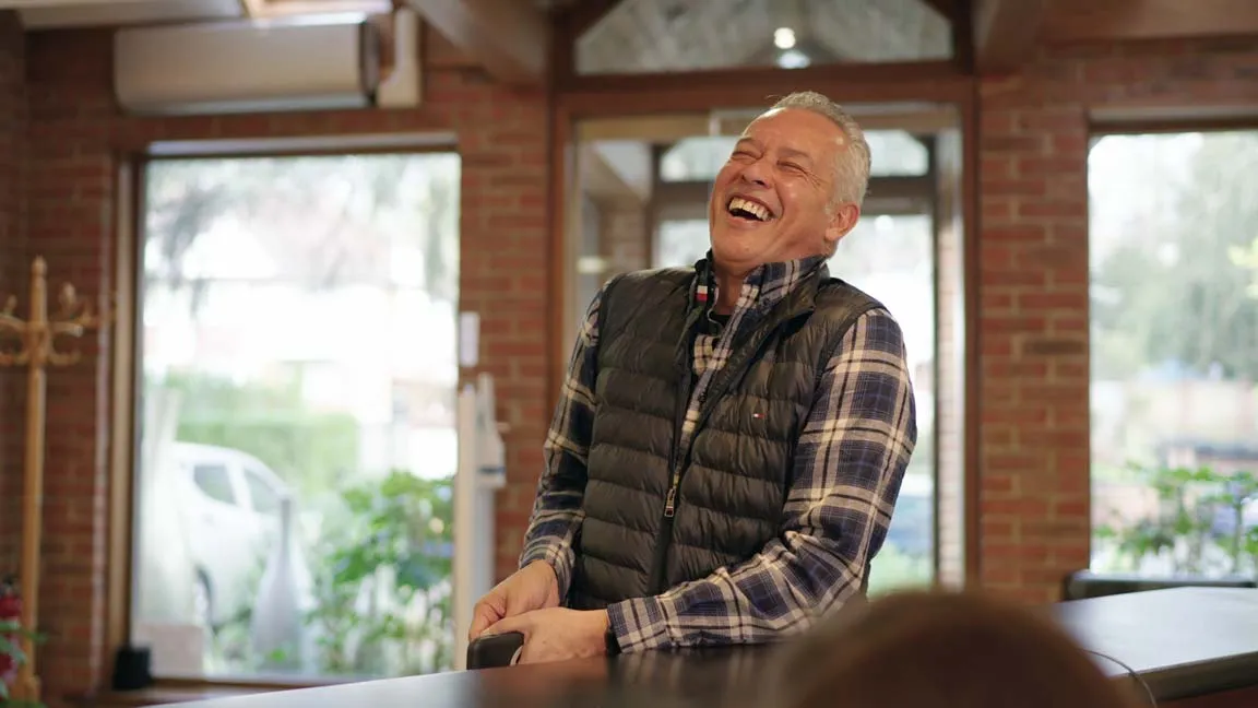 Happy patient enjoying new smile after All-on-4 dental implants at Foxley Lane Dental, Purley dentist serving Selsdon and South Croydon