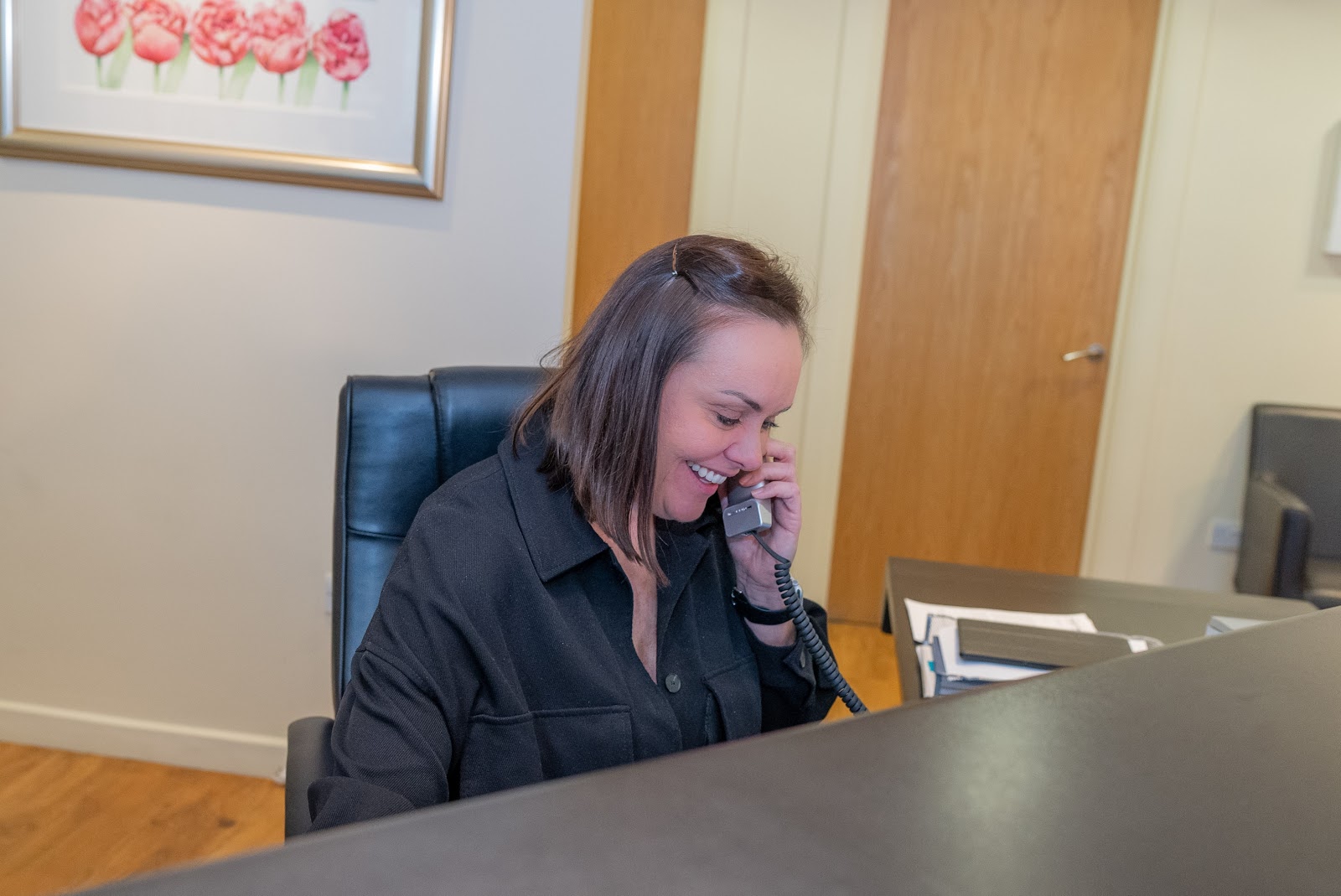 Receptionist at Foxley Lane Dental taking a call to arrange a same-day appointment with an emergency dentist near Purley