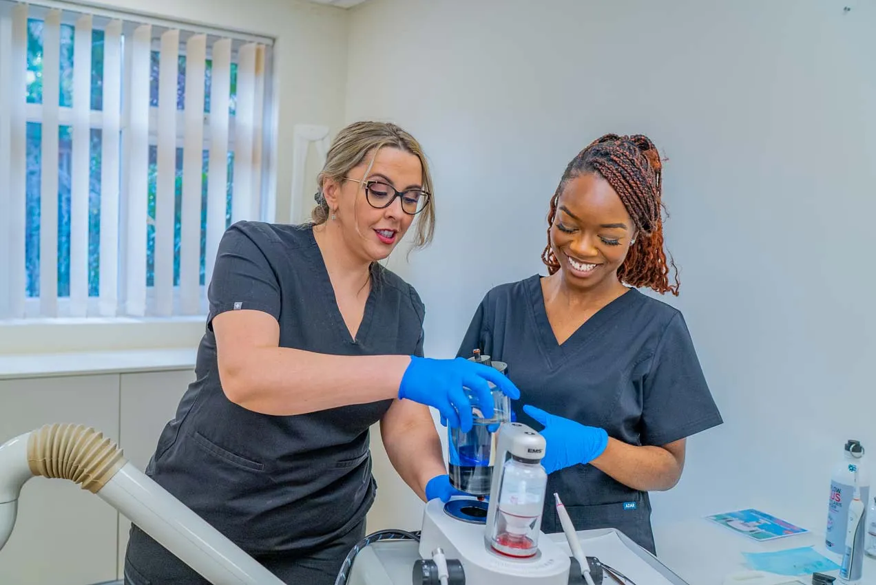 Dental team at Foxley Lane Dental preparing hygiene equipment in a modern treatment room in Purley