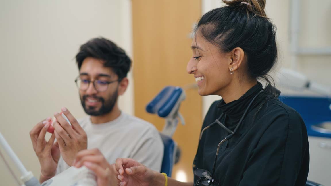 Purley dentist explaining fluoride vs hydroxyapatite toothpaste options to a patient, Foxley Lane Dental, South London.