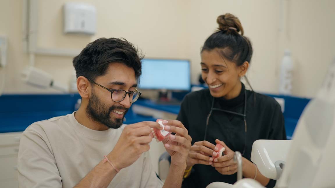 Purley dentist explaining safe veneer options to a patient at Foxley Lane Dental, discussing alternatives to dental tourism abroad.