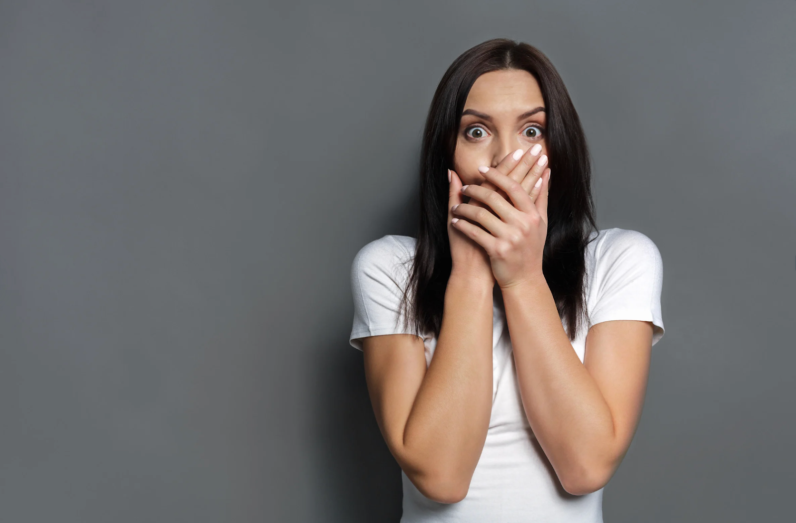 Worried woman covering her mouth after dental trauma or knocked-out tooth, needing an emergency dentist in Purley