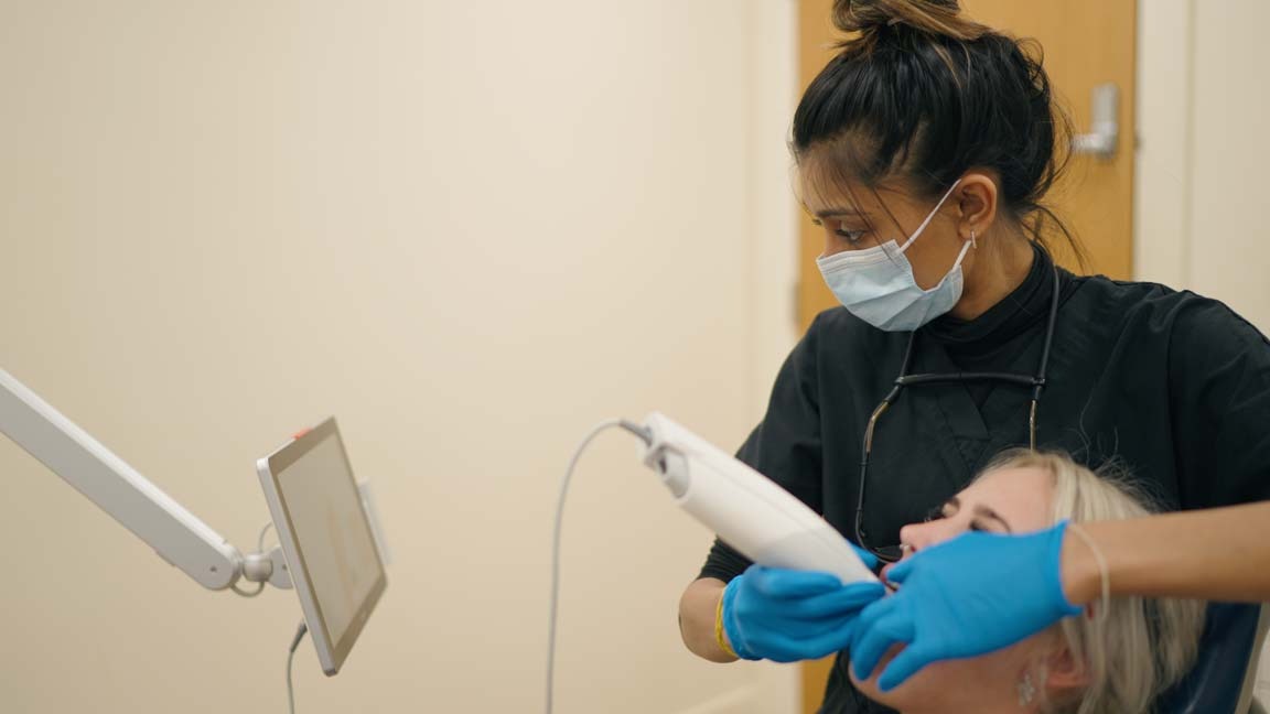 Dentist Punita Shah using digital scanning technology during cosmetic dental consultation at Foxley Lane Dental Clinic in Purley