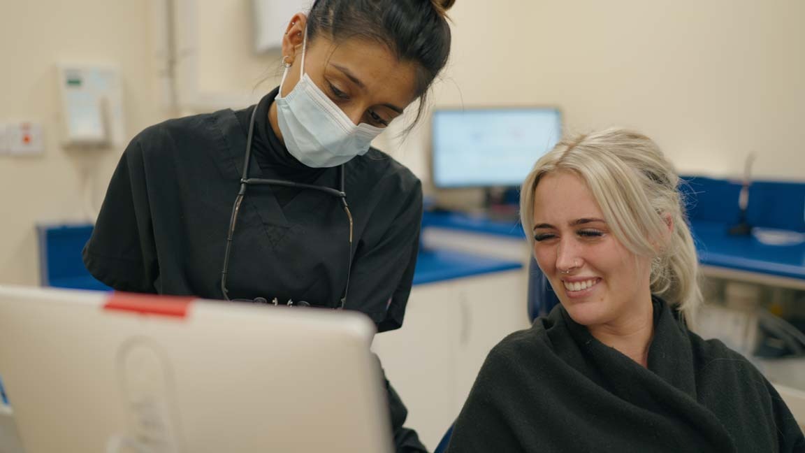 Dentist Punita Shah at Foxley Lane Dental showing a patient their digital smile design on a computer screen during a cosmetic dentistry consultation