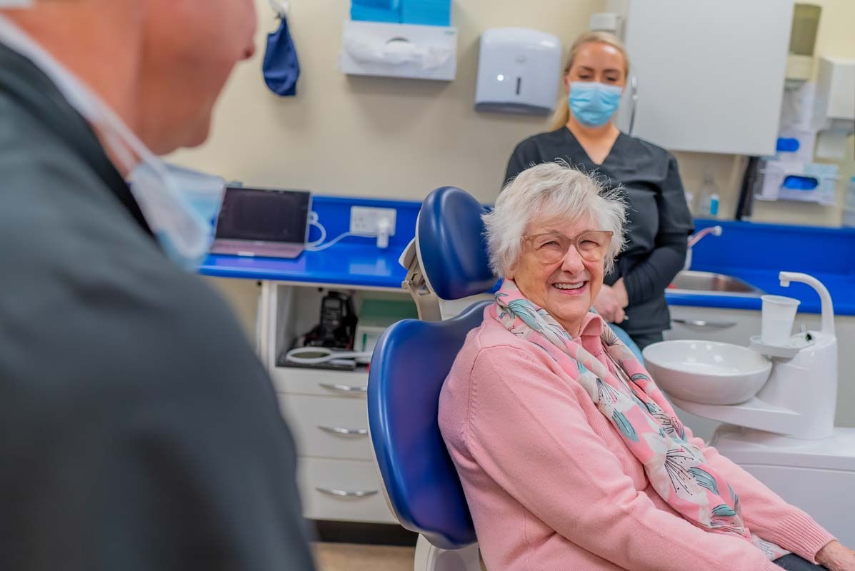 Older patient smiling during a dental consultation for dental implants at Foxley Lane Dental Clinic in Purley.