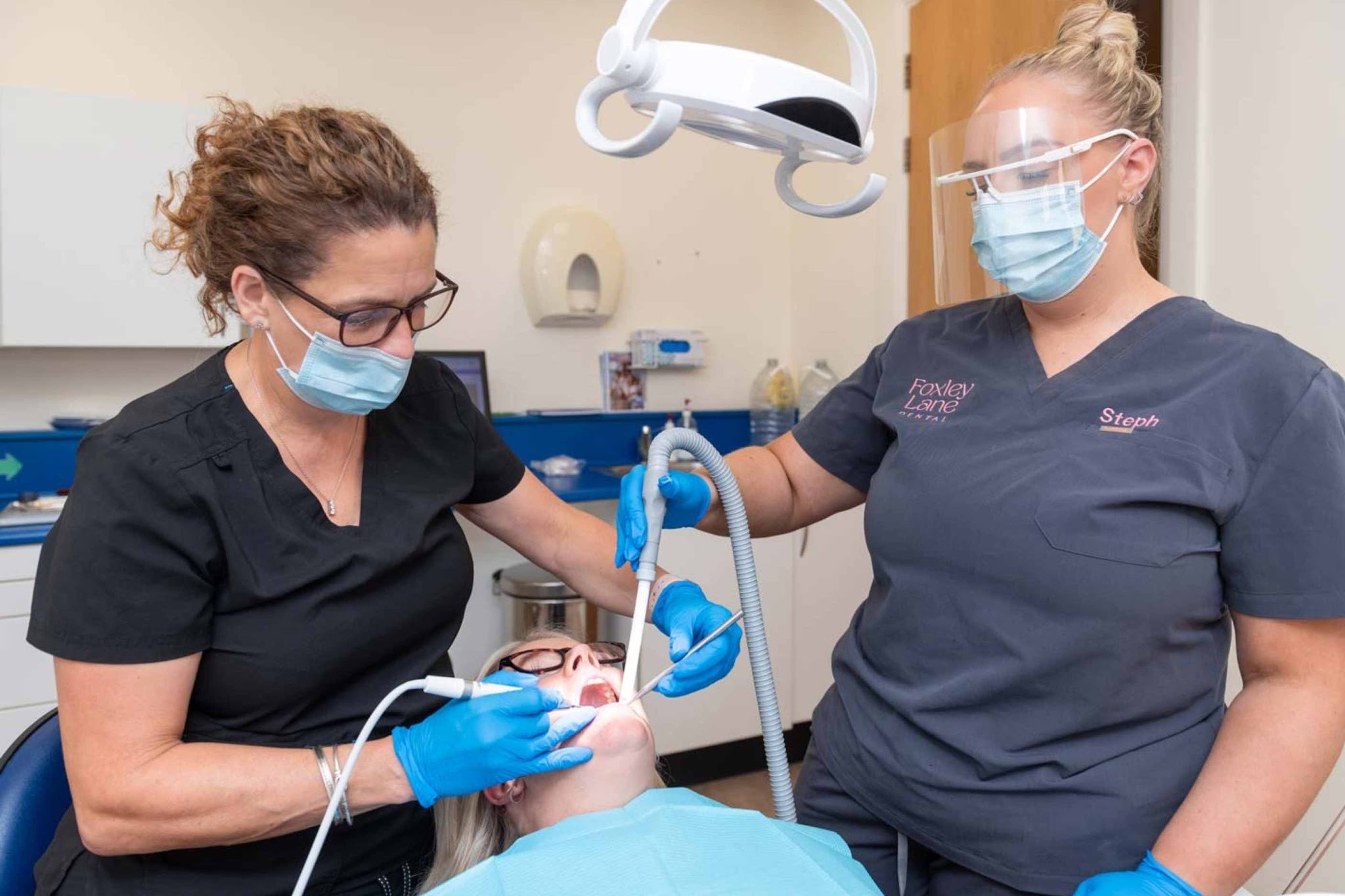 Dentist and dental nurse providing cosmetic dental treatment at Foxley Lane Dental Purley