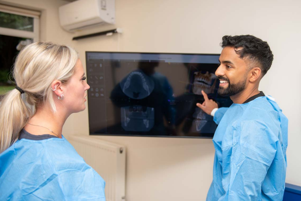 Dr Nev discussing dental implant treatment planning using 3D CT scans at Foxley Lane Dental Purley