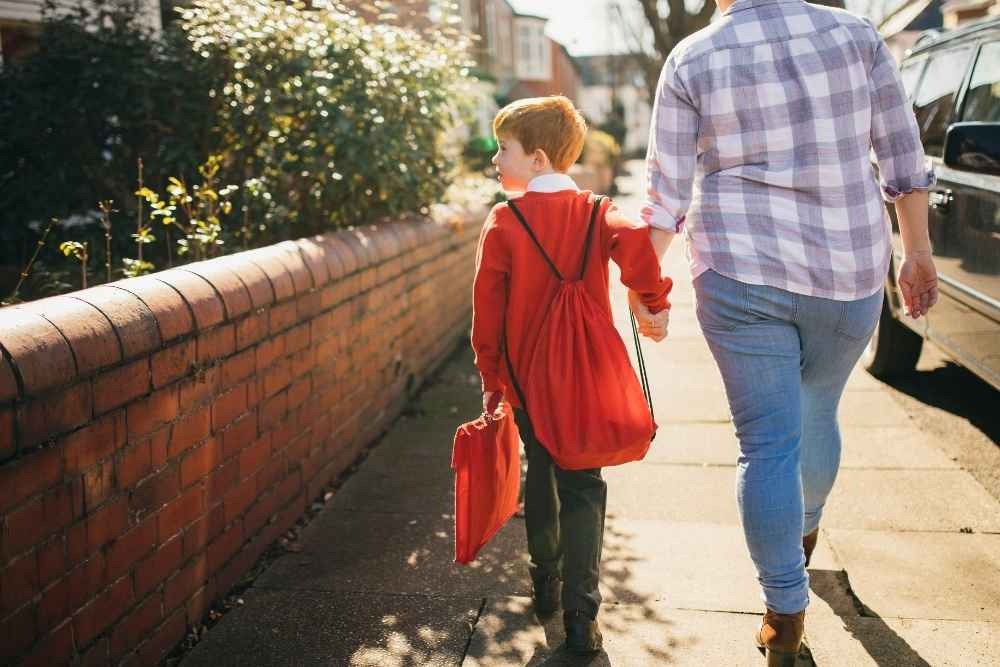 Parent and child walking to school as part of their back-to-school routine