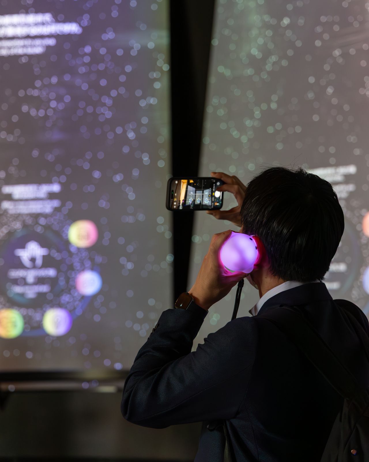 Visitor holding and using the Circular audioguide inside the German Pavilion, designed by Futurewave and facts and fiction.
