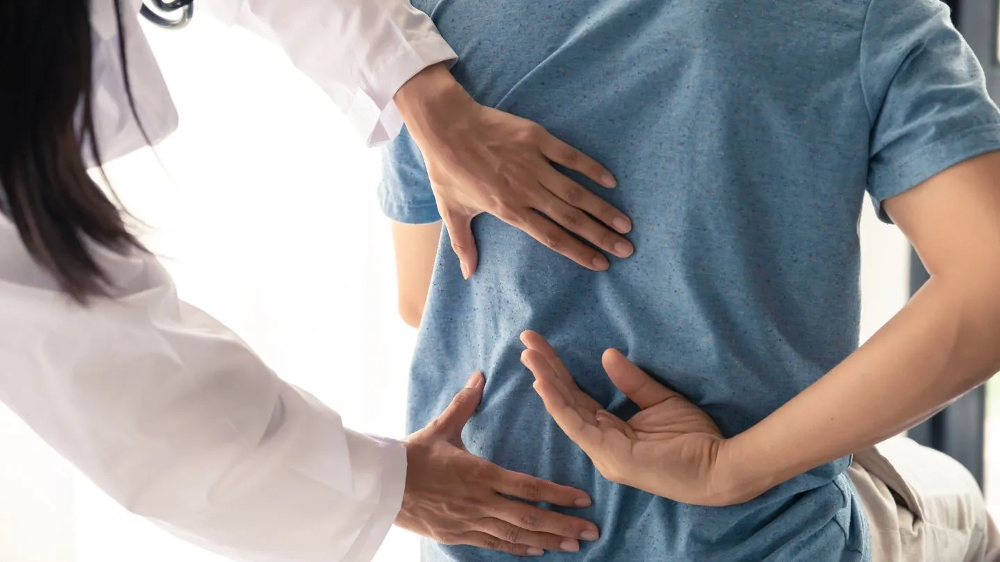 chiropractor assessing a patient for back pain