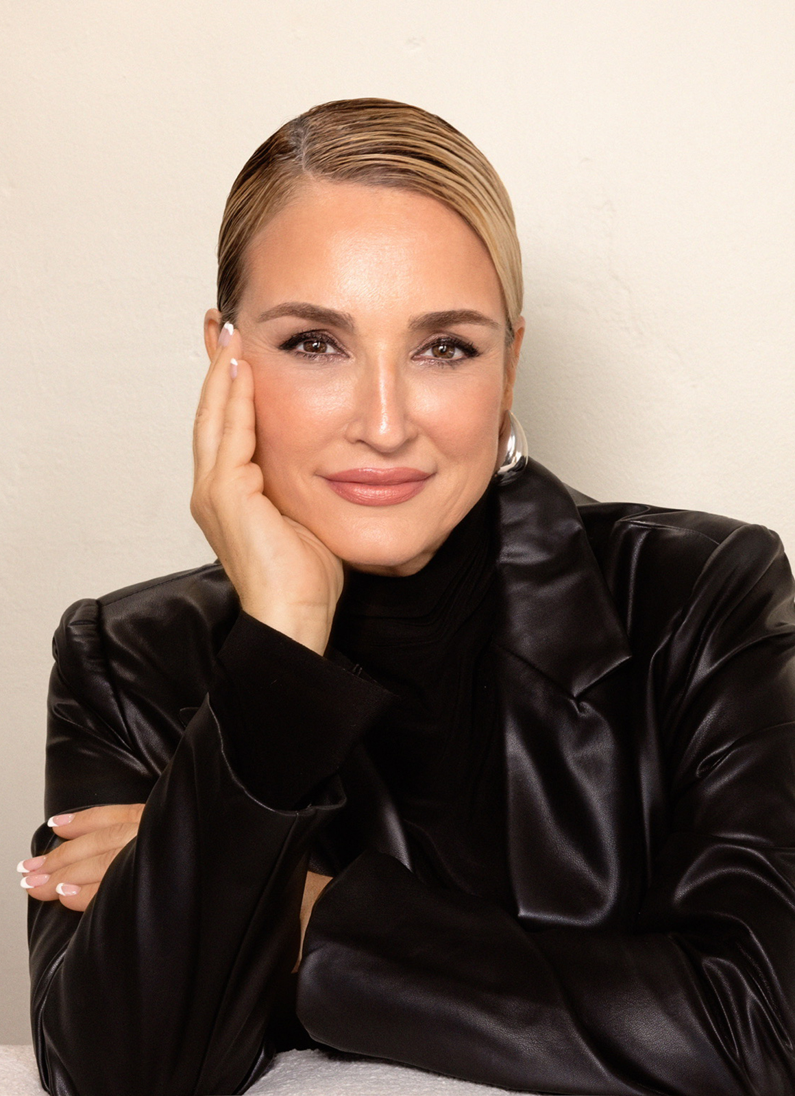 A woman posing with her hand below her chin