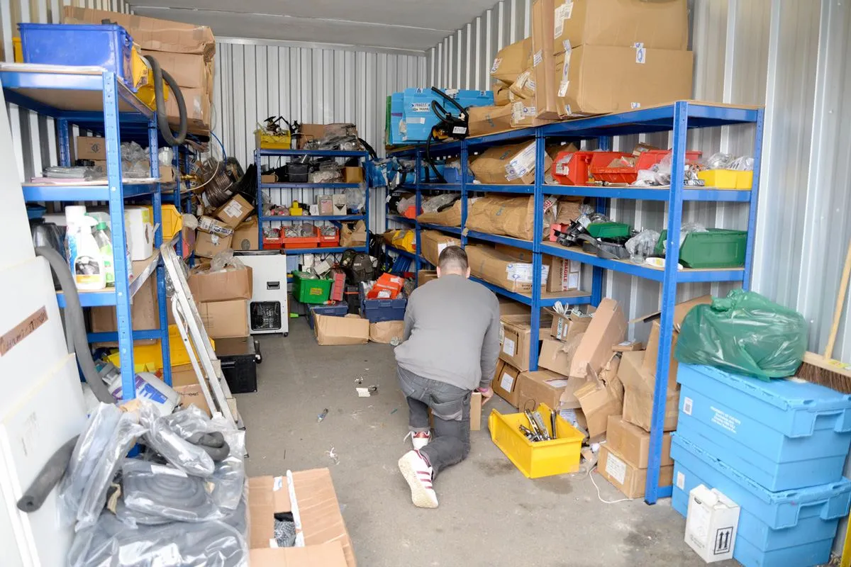 a man is walking through a storage area