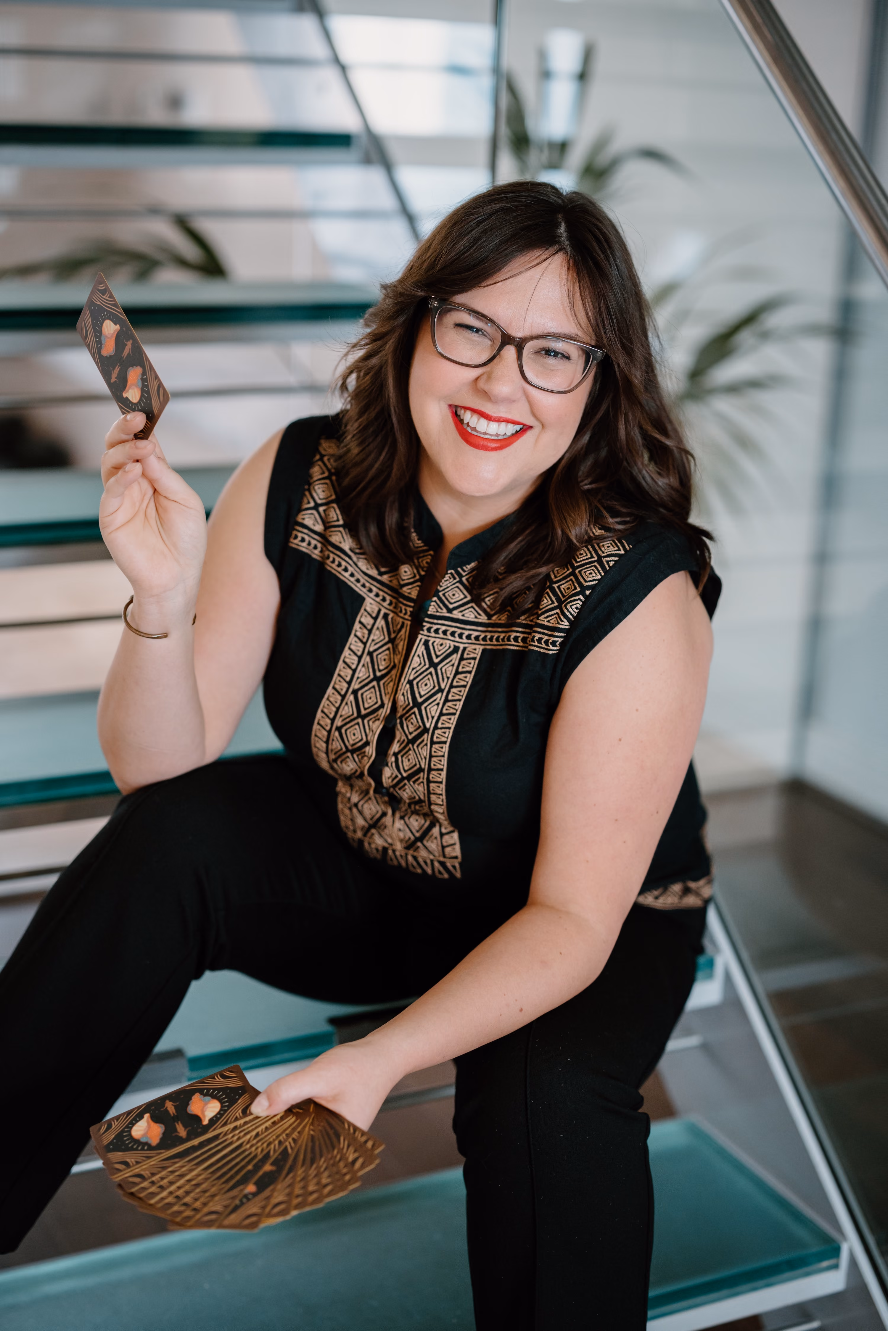 Jessica Paschke holding tarot cards.