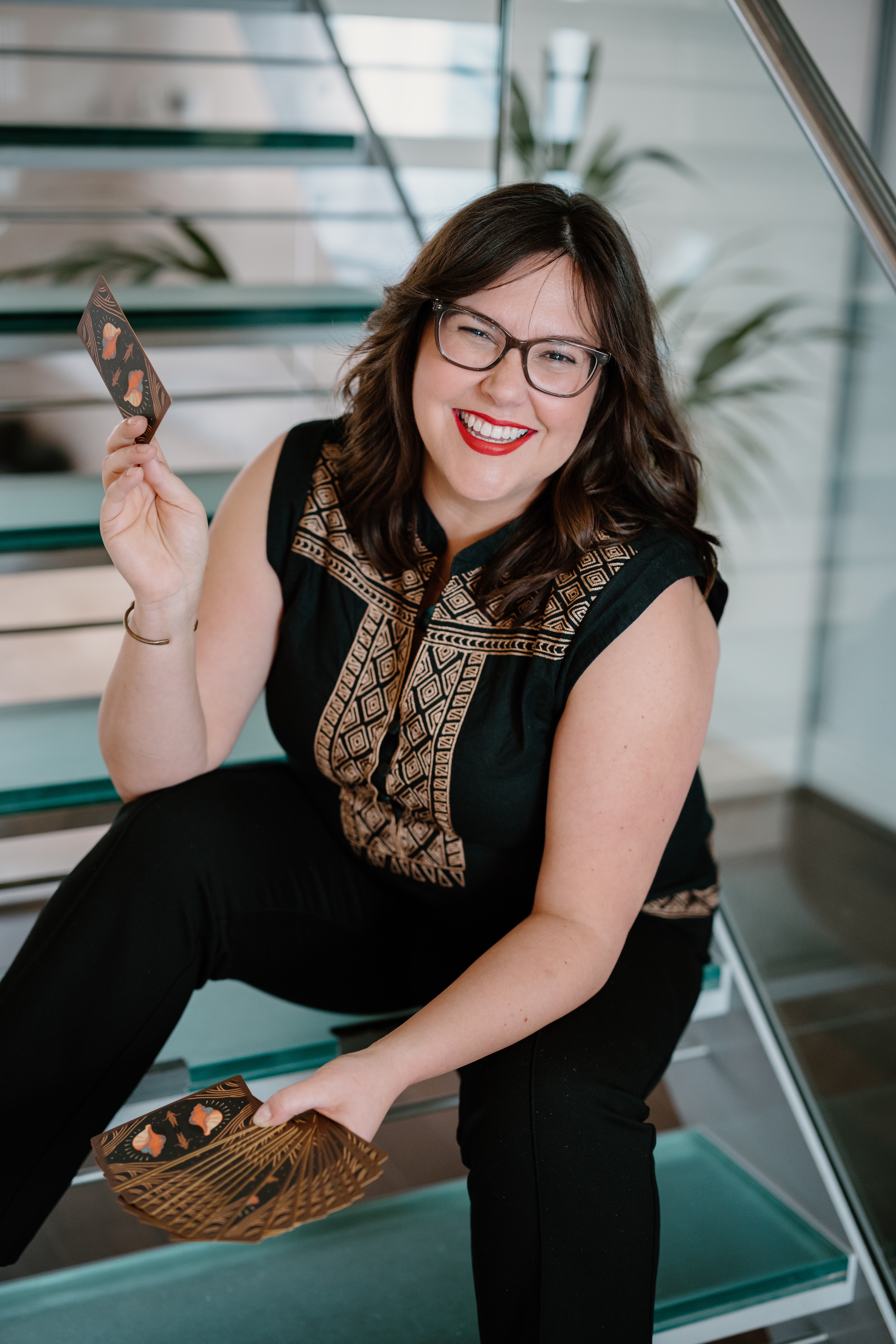 Jessica Paschke holding tarot cards.