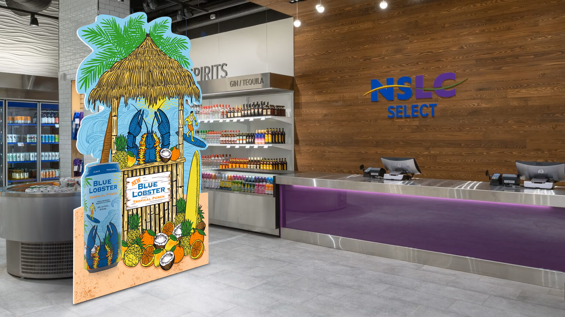 In-store Nova Scotia Liquor Commission display of a blue lobster in a tiki hut serving fruit. Large can mock up to the right of tiki hut and fruit in the foreground.
