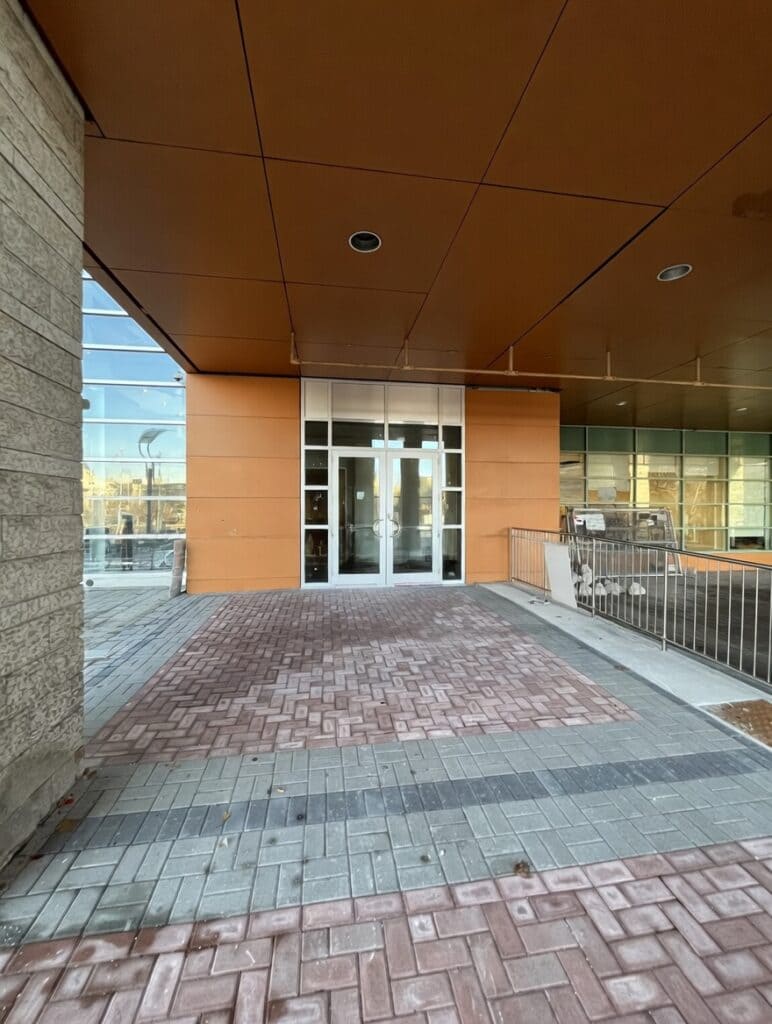 Main entrance of building with interlocking brick walkway. 