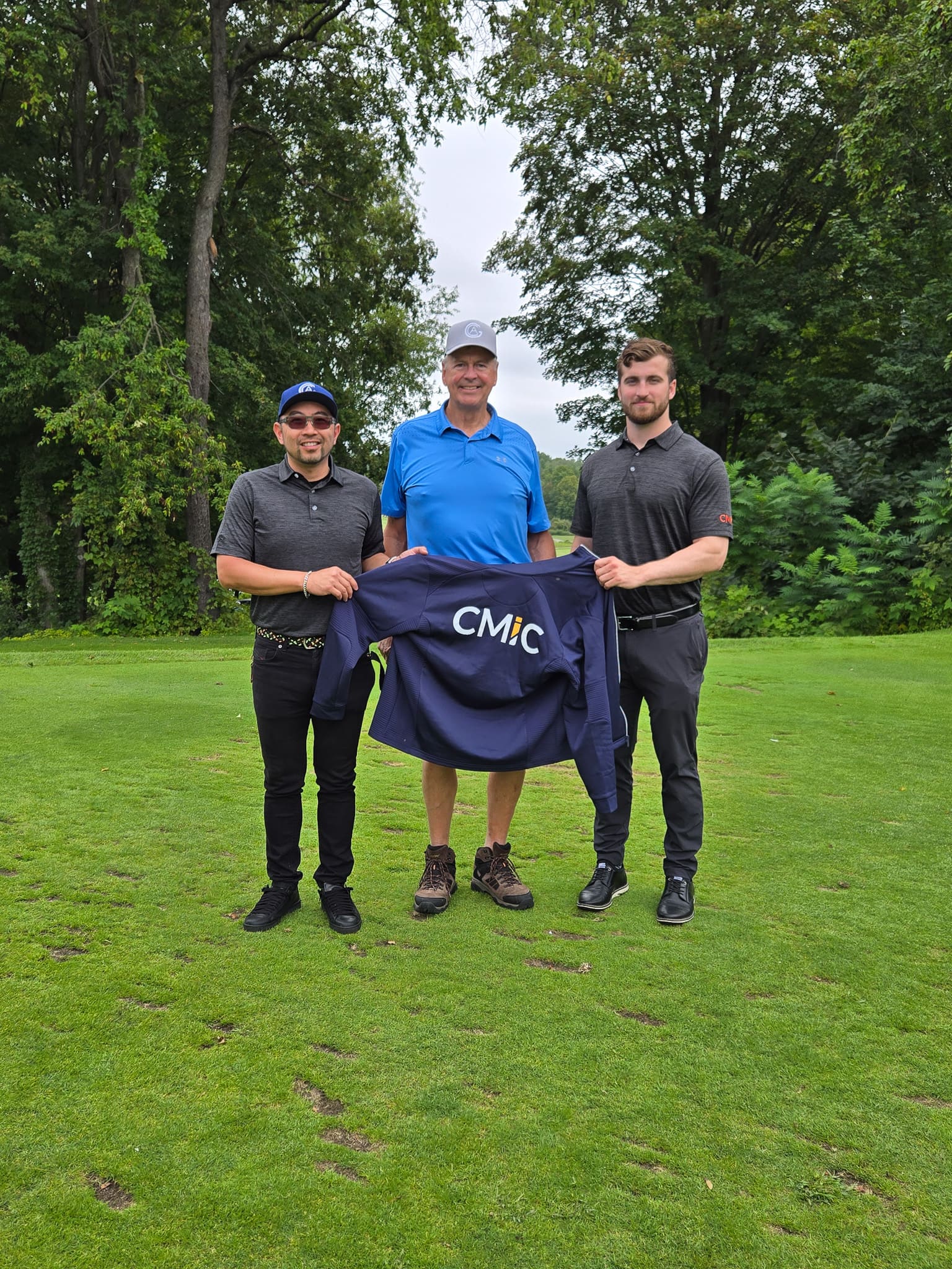 Group standing together on golf course green