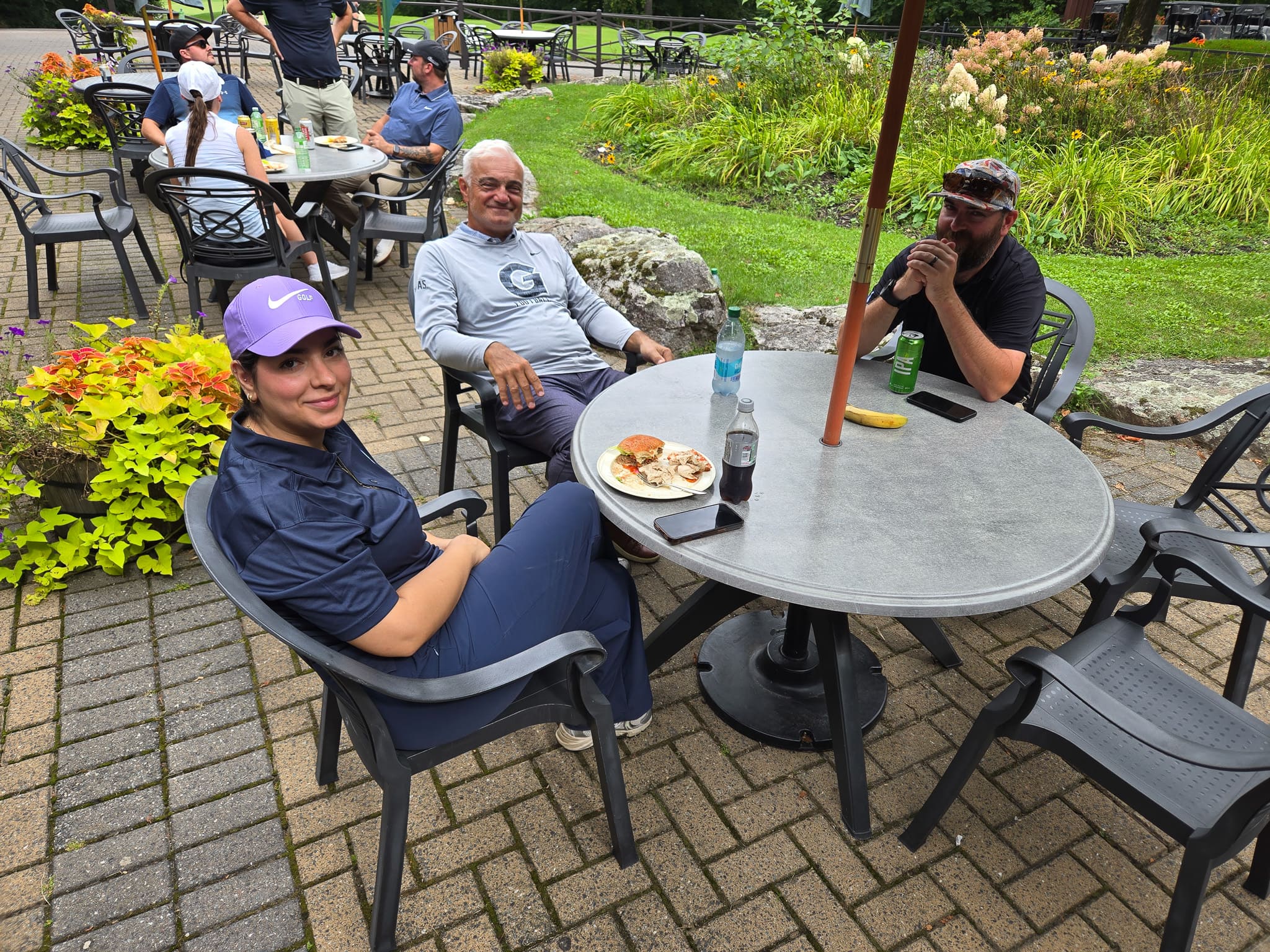 Group sitting at a table at golf course