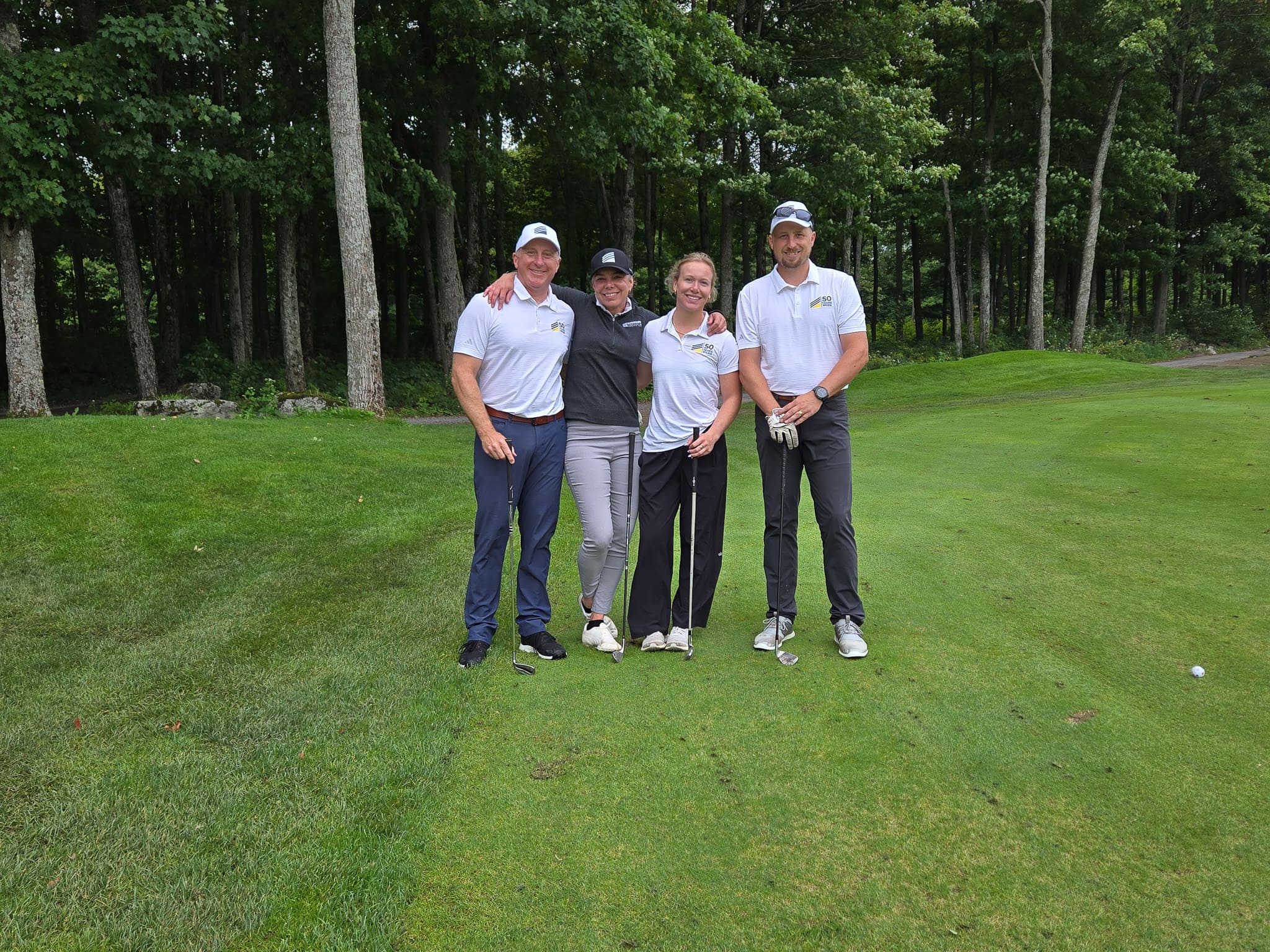 Group standing together on golf course green