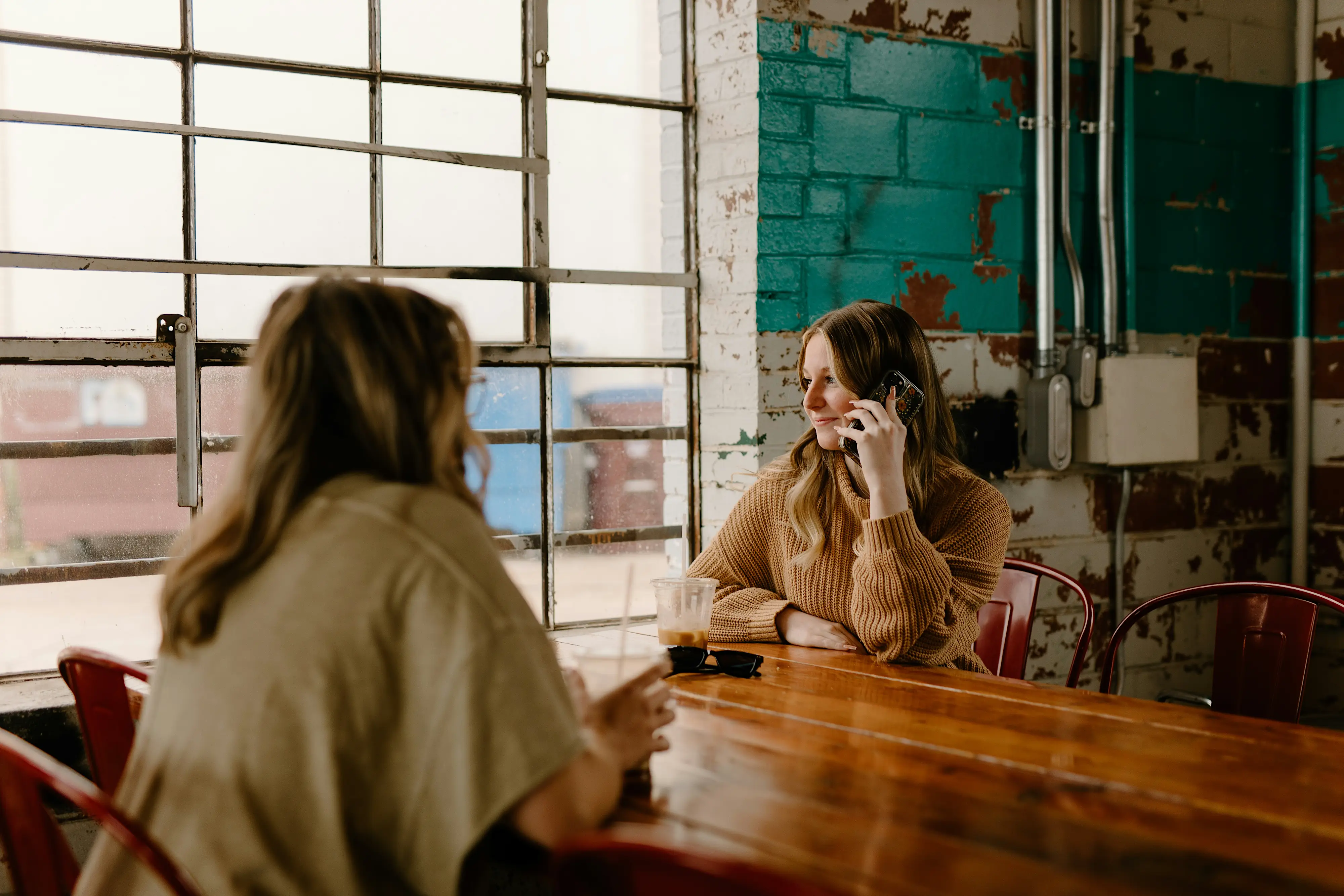 Woman on phone in crowded cafe