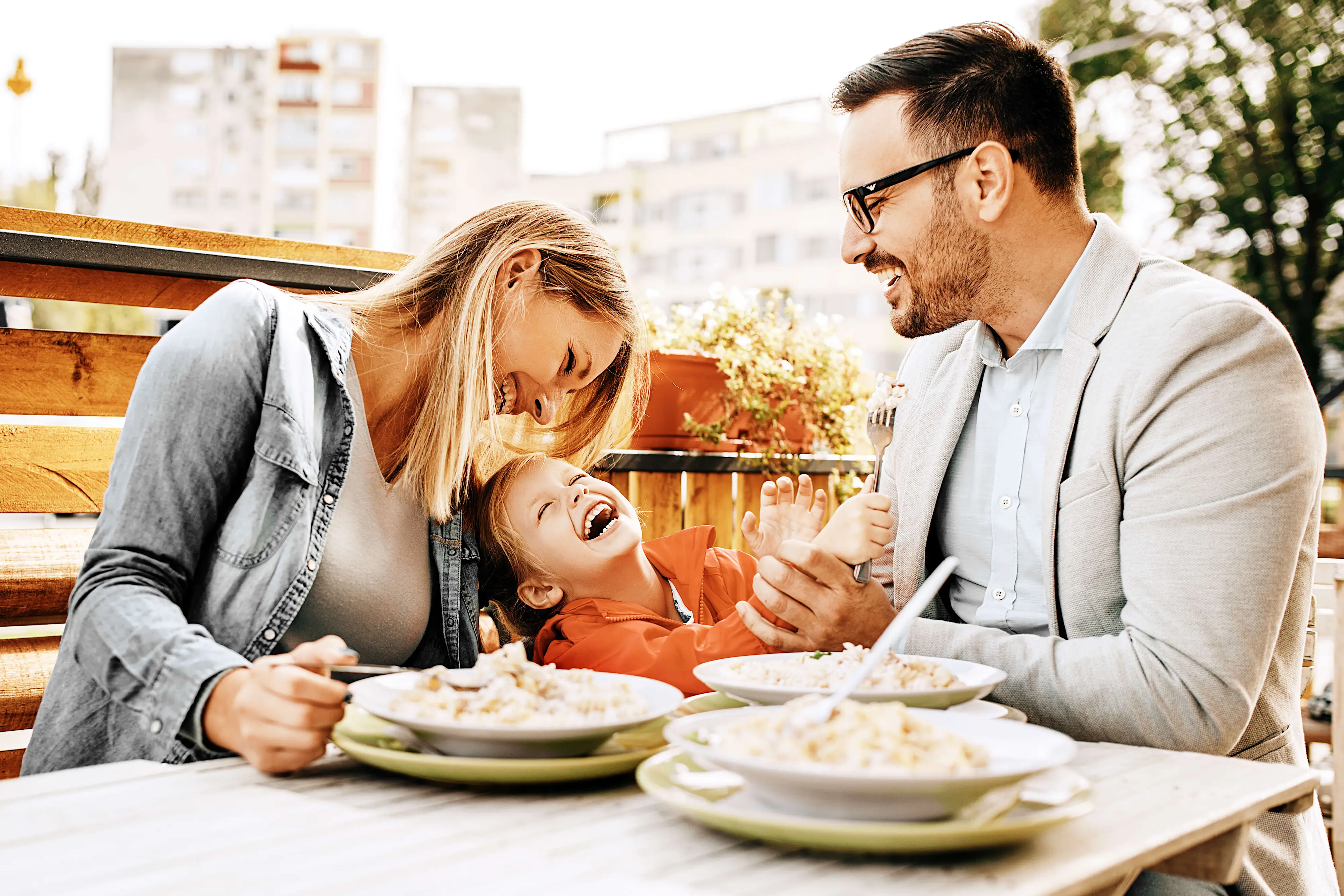 Family laughing and enjoying dinner at home