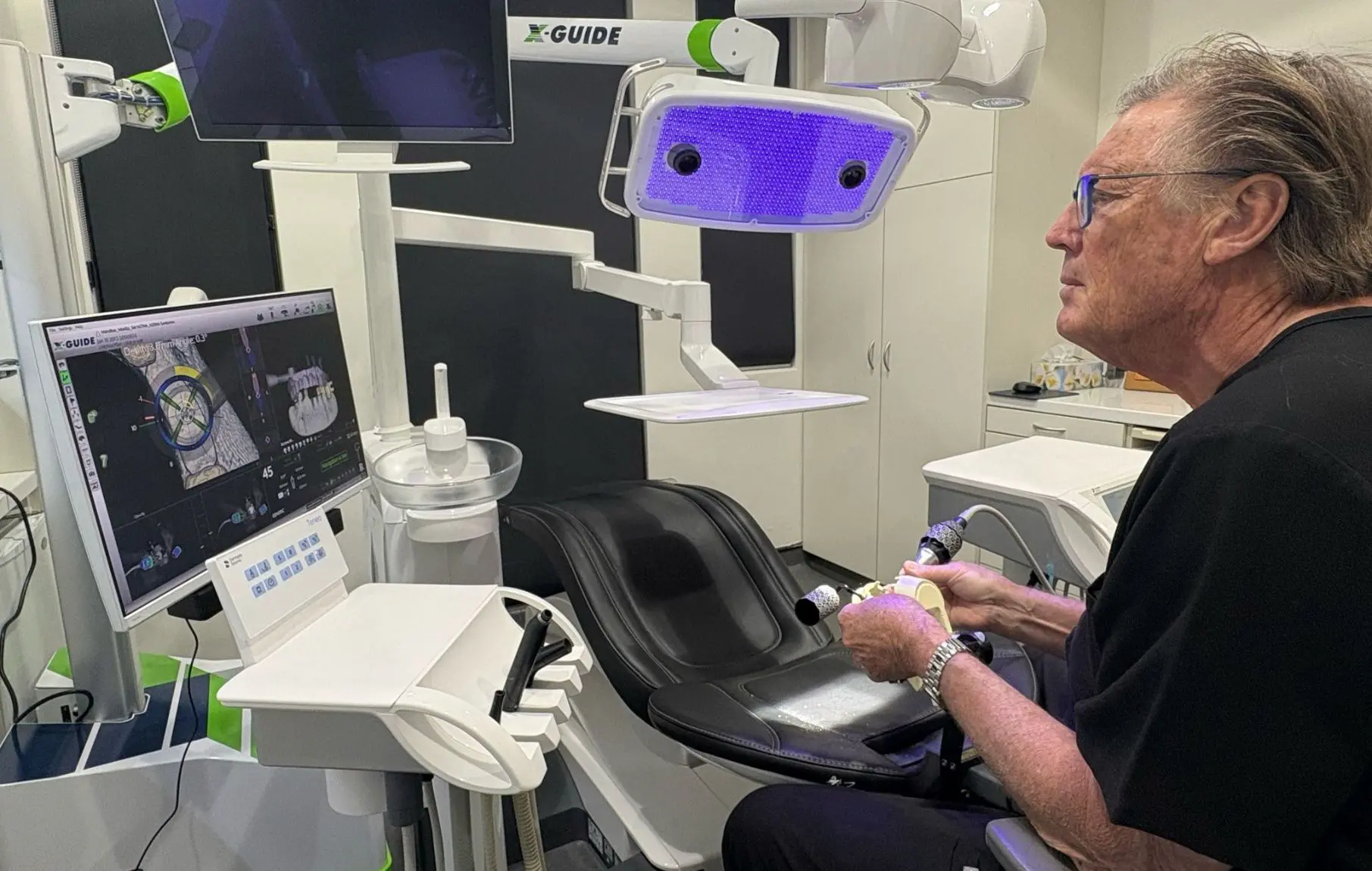 Dr David Dunn uses X guide to carefully place dental implants during surgery at Macquarie Street Dental.