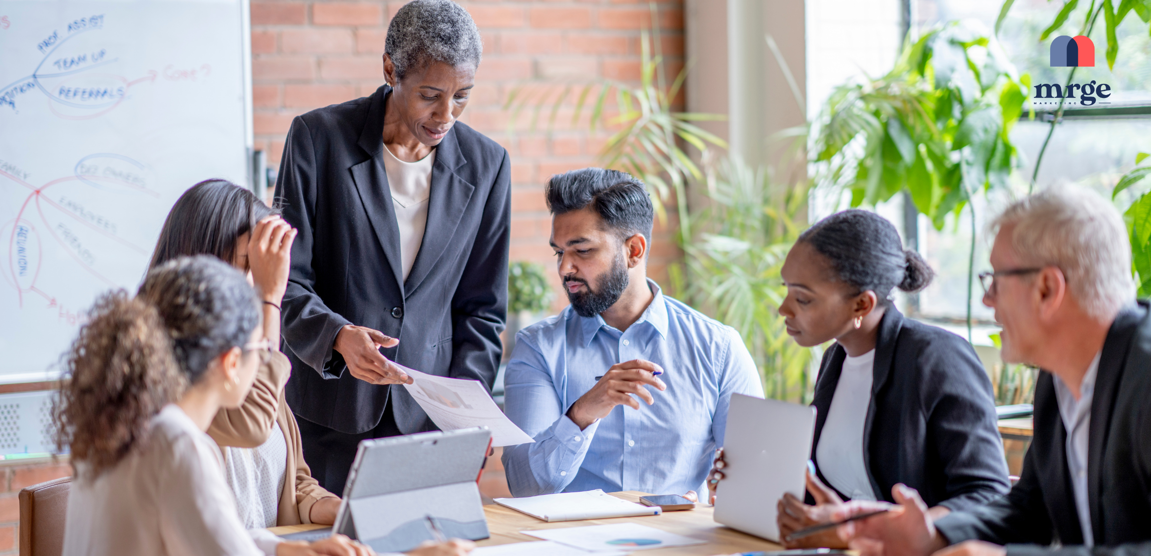 a marketing leader at her desk reviewing reports.
