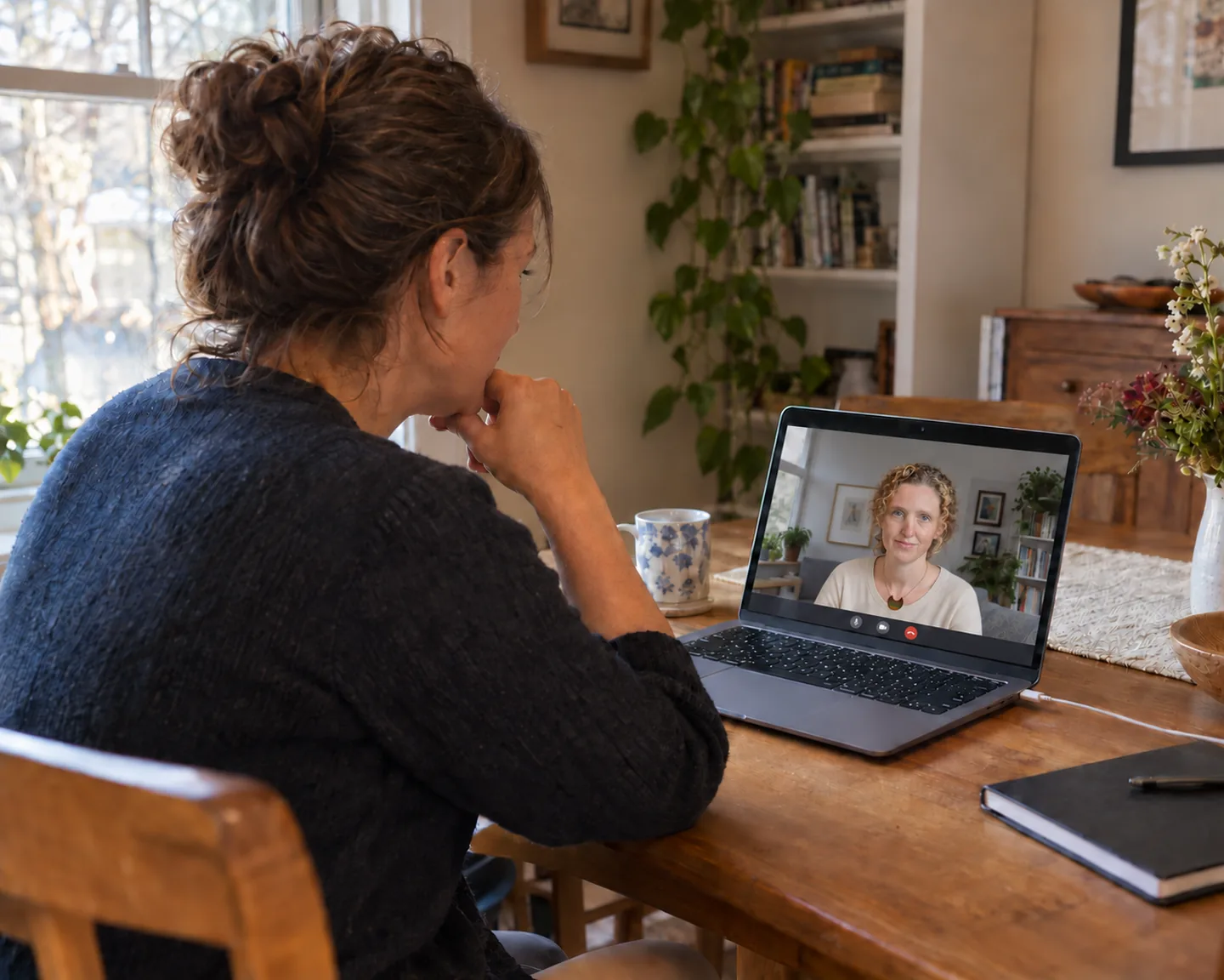 Person at home on a laptop video call with their therapist