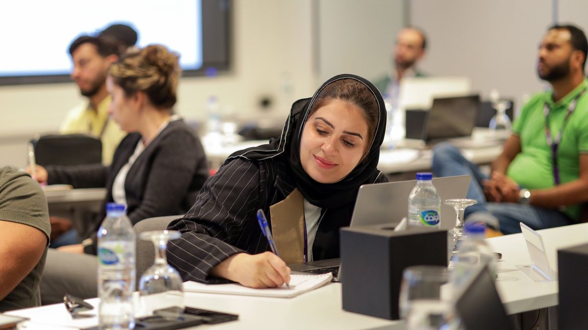 Global MBA participant taking notes during a workshop