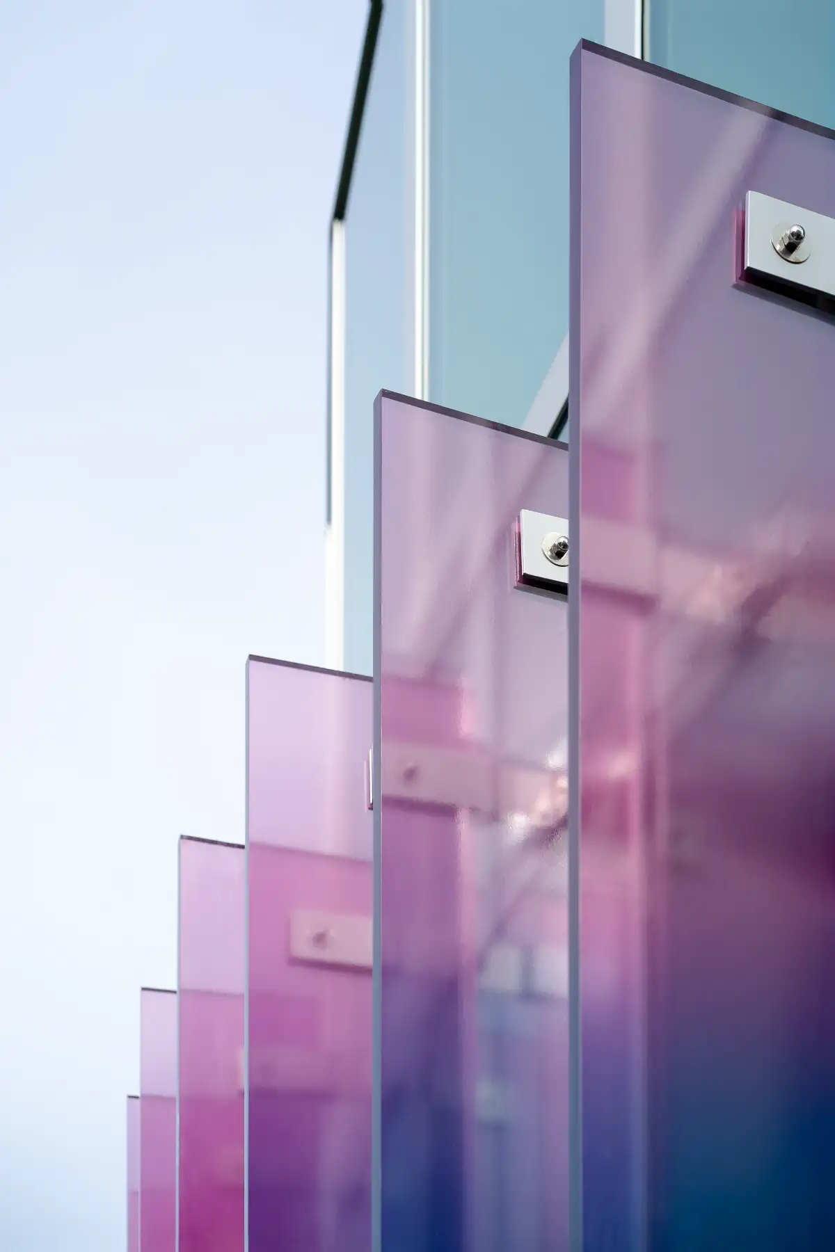 3form architectural glass panels in iridescent purple and pink gradient, showcasing translucent resin material design for building facades