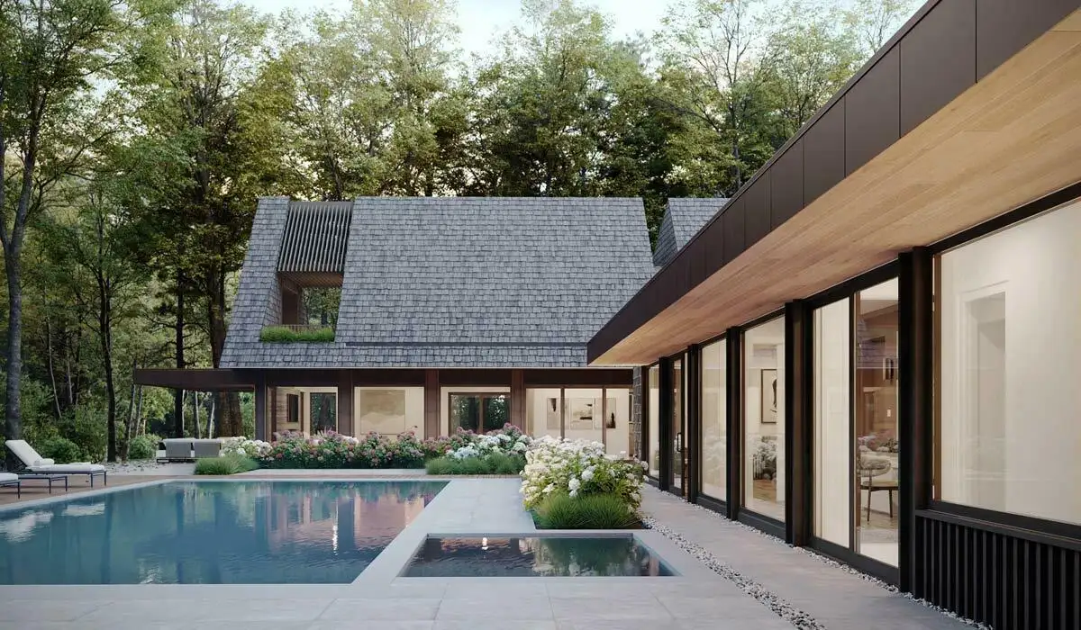 Brava roofing on a modern shingle-style home with pool, hydrangea gardens, and floor-to-ceiling glass walls surrounded by woodland