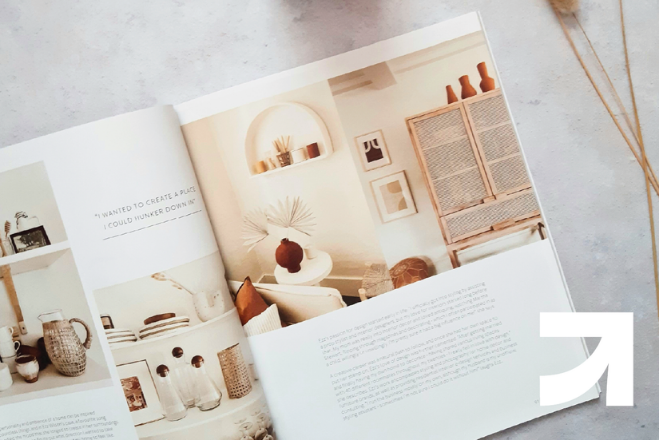 An AEC publication sites open on a white stone counter top. UpSpring logo to the bottom right.