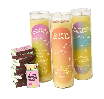 three candles and a stack of match boxs