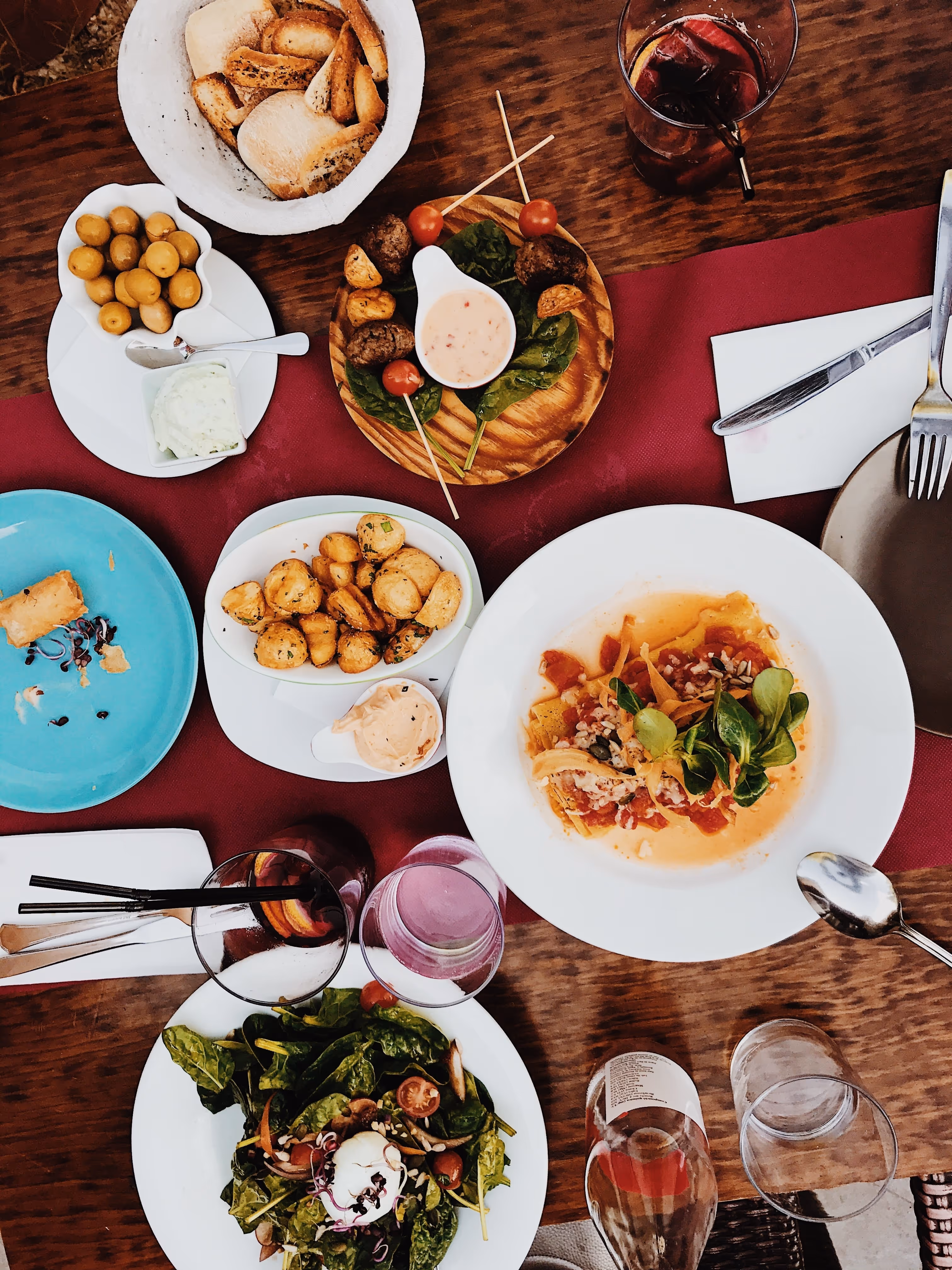 Flat lay view of food dishes on a table, representing the local dining options near The Lofts at Wolf Pen Creek.