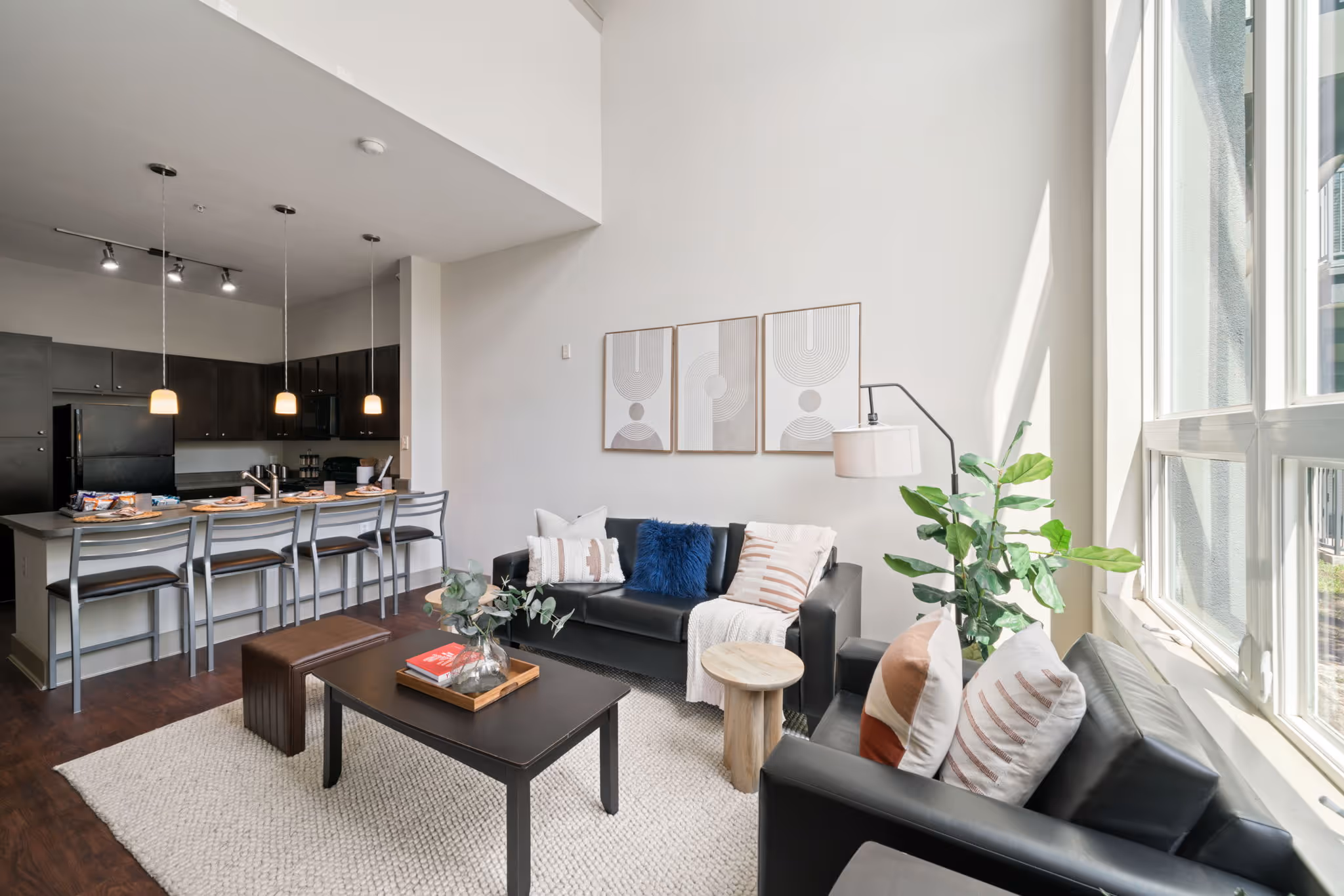 Bright social space highlighting the transition from the kitchen bar to the comfortable living room.