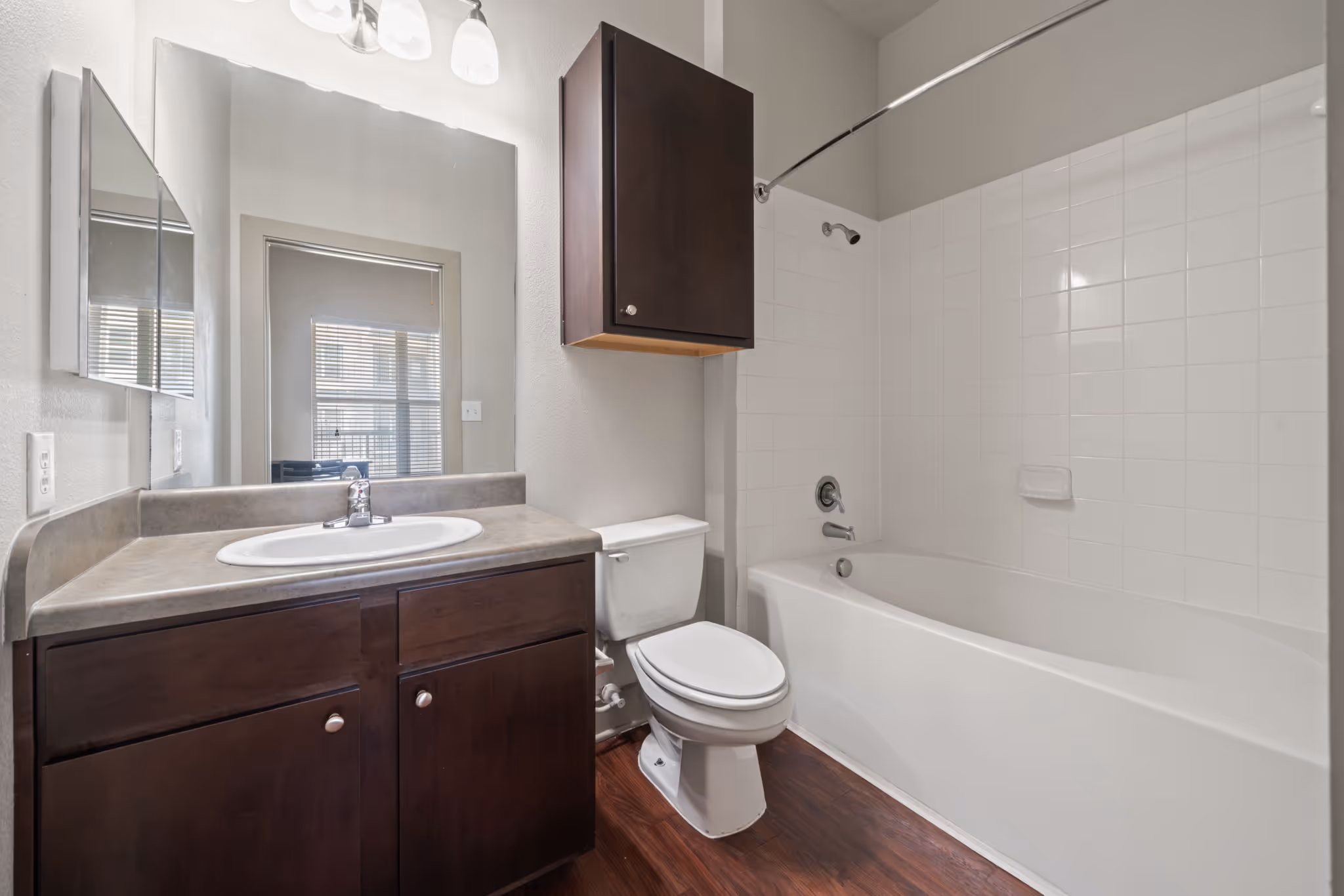 Bright bathroom design with white tiles and a spacious bathtub at The Lofts at Wolf Pen Creek.
