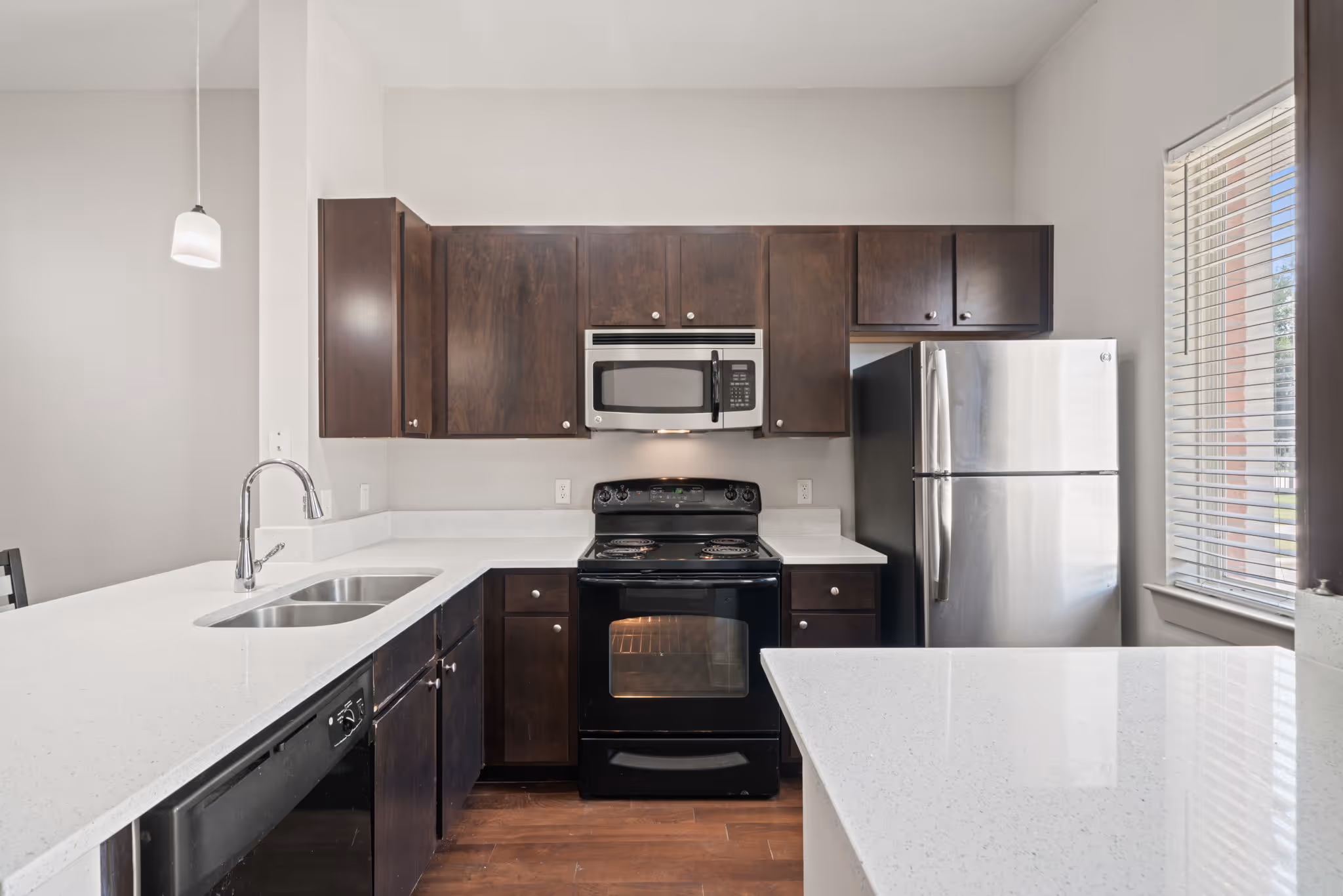 Fully equipped kitchen at The Lofts at Wolf Pen Creek featuring a breakfast bar and modern appliances.