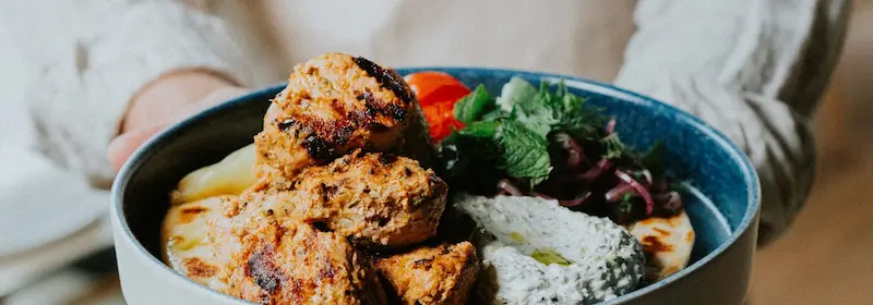 A close up of a bowl of food with meat.