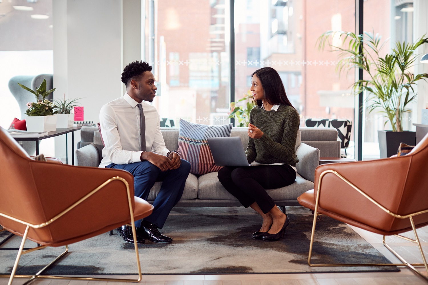 Two professionals having a discussion in a modern office.