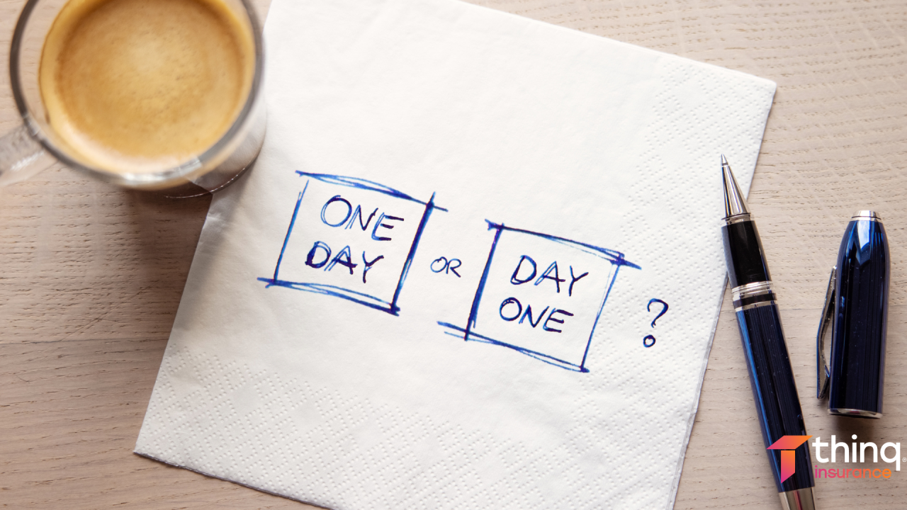 Napkin with 'One Day or Day One?' written beside coffee and pens.