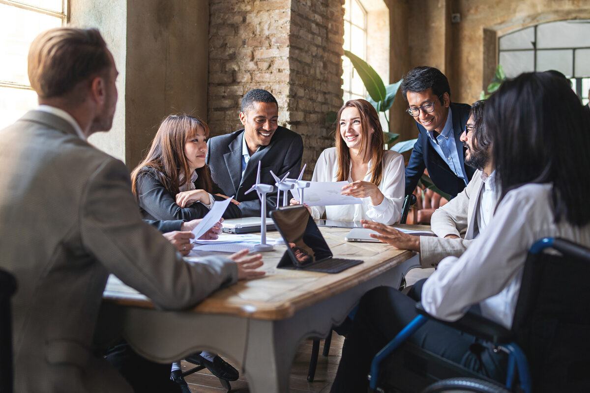 Group of professionals collaborating around a table in an office.