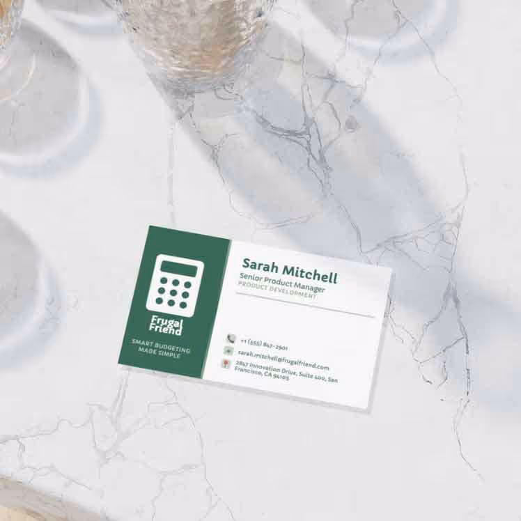 Business card for Sarah Mitchell, Senior Product Manager at Frugal Friend, with contact details and logo on a marble surface.