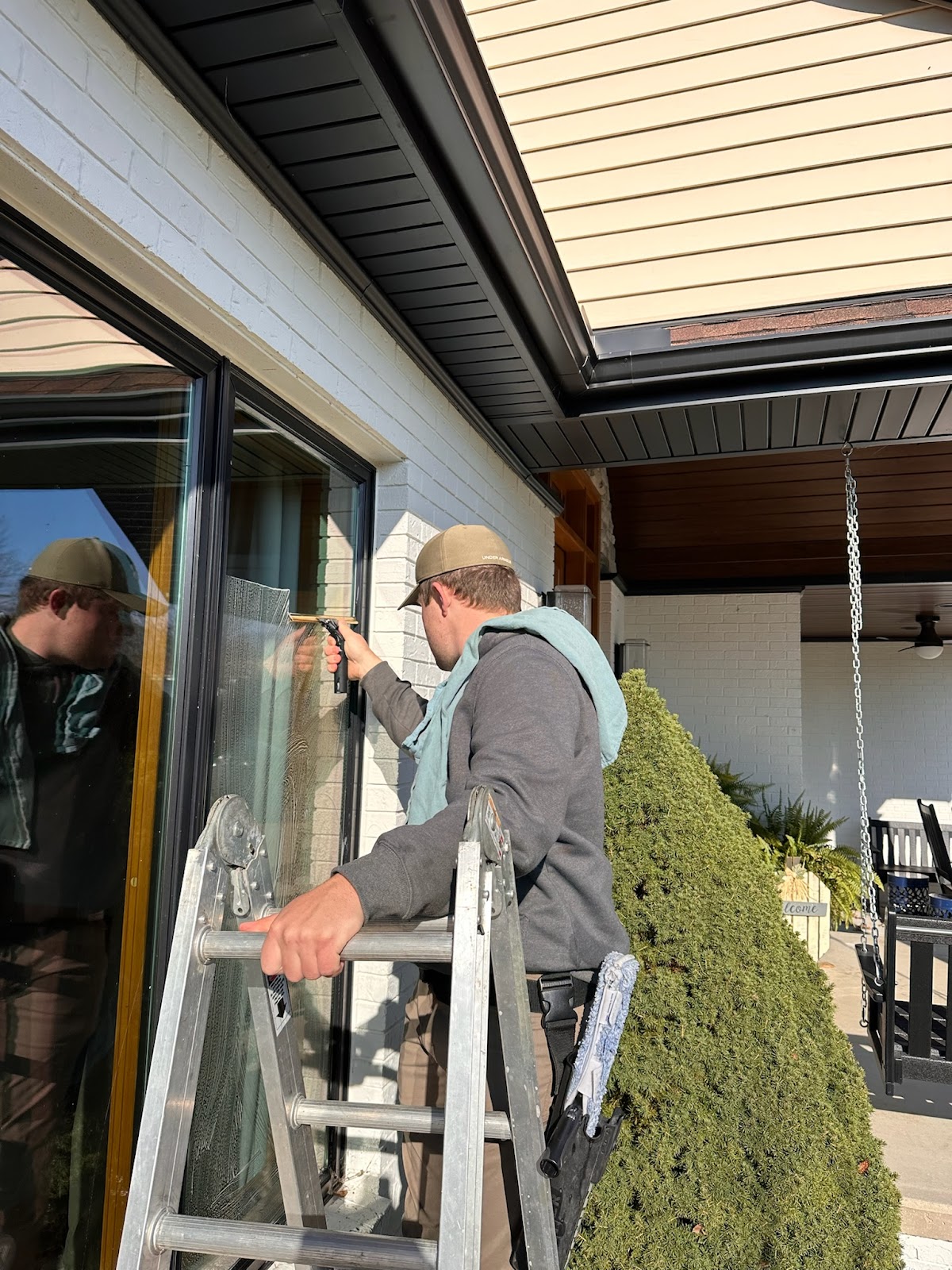 technician cleaning regular window