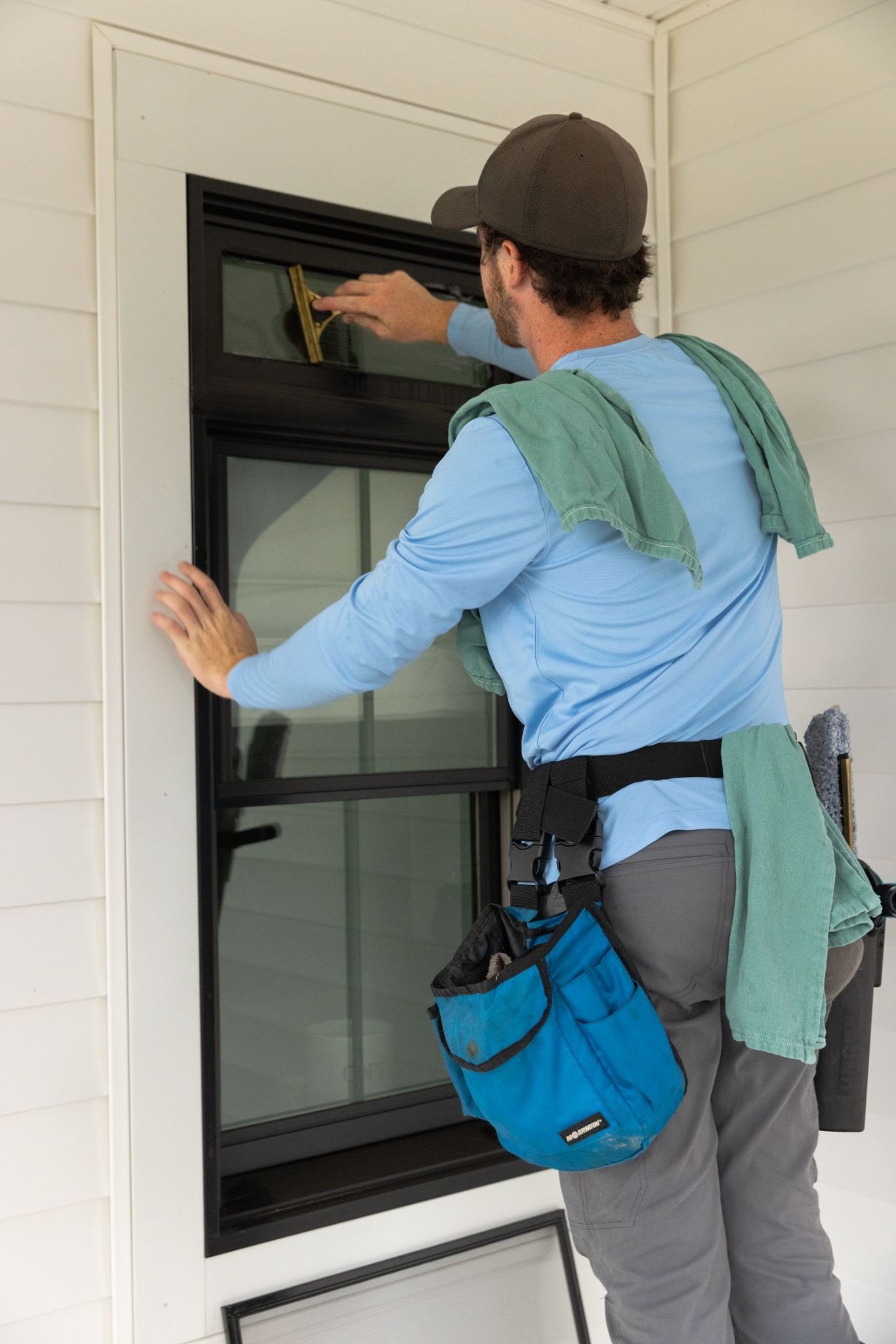 Technician cleaning window