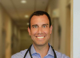 Dr. John Bacha smiling.