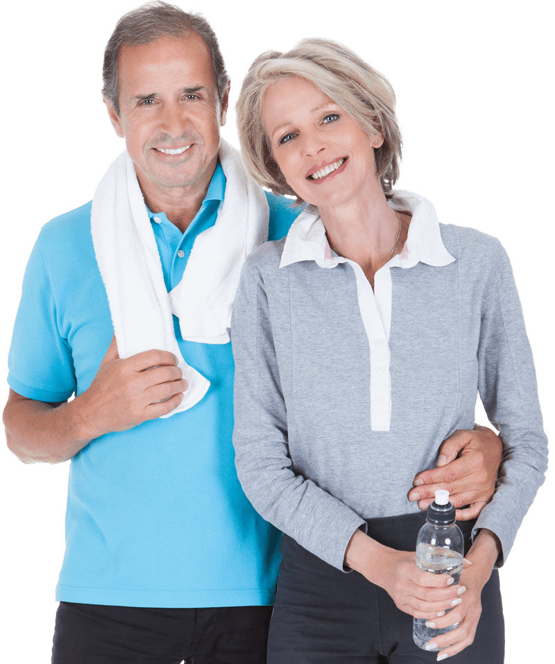 A happy elderly couple standing affectionately while smiling. 