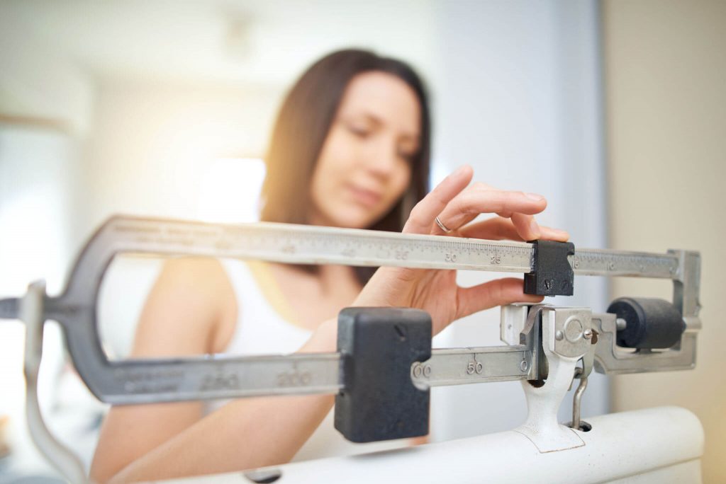 Weight Loss 33458 woman measuring weight