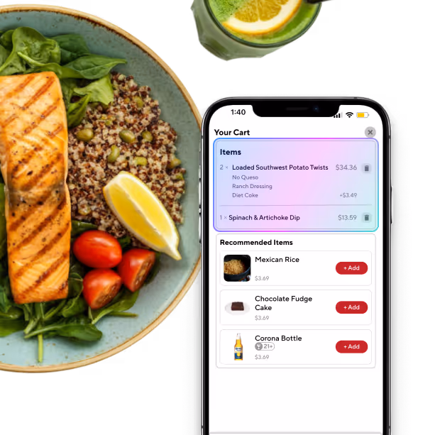 Smartphone displaying a food ordering app cart with loaded Southwest potato twists and spinach & artichoke dip, next to a plate with grilled salmon, quinoa, cherry tomatoes, spinach, and a lemon wedge.