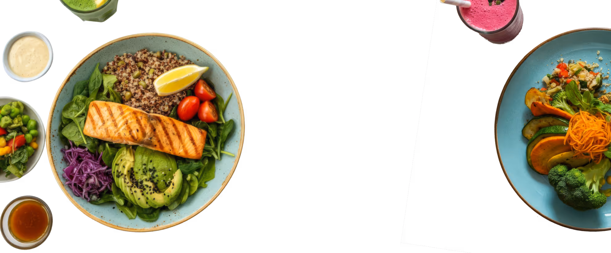 Two plates of healthy meals with grilled salmon, avocado, quinoa, leafy greens, colorful vegetables, and three small sauce containers, plus two smoothies, one green and one pink.