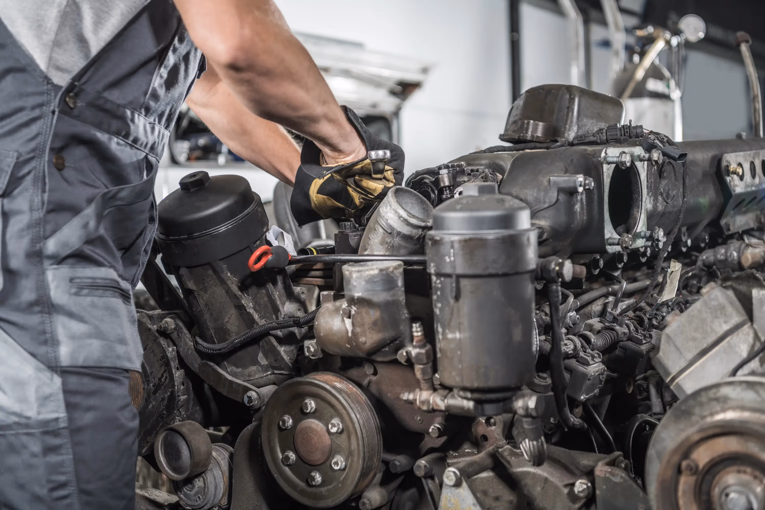Mechanic performing alternator repair on semi truck in Los Angeles, CA